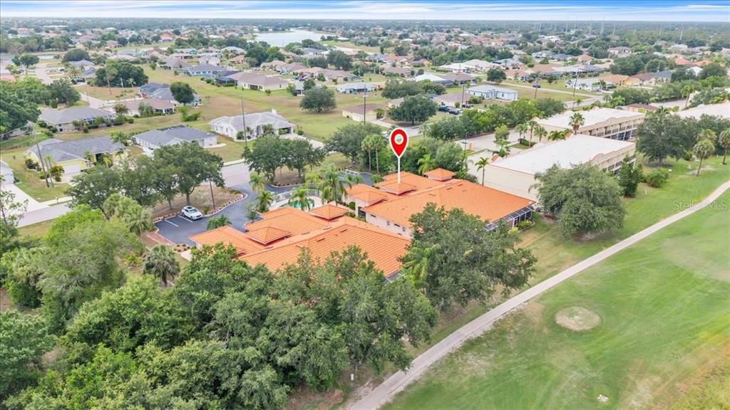 1260 Rio De Janeiro Avenue, Unit 102 Punta Gorda, FL 33983 - Photo 43 of 46 an aerial view of a residential houses with outdoor space and trees
