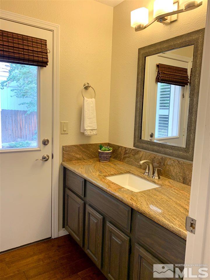1551 Bramble Court Reno, NV 89509 - Photo 15 of 30 a bathroom with a granite countertop sink and a mirror