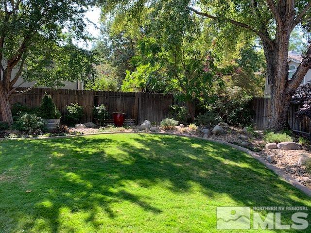 1551 Bramble Court Reno, NV 89509 - Photo 23 of 30 a view of patio with a table and chairs under an umbrella