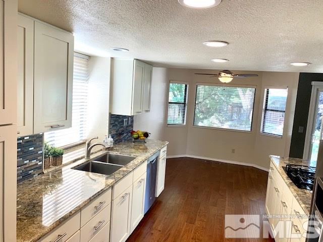 1551 Bramble Court Reno, NV 89509 - Photo 5 of 30 a kitchen with granite countertop a sink a counter space appliances and cabinets