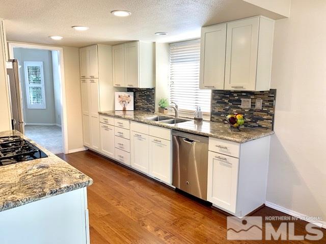 1551 Bramble Court Reno, NV 89509 - Photo 6 of 30 a kitchen with stainless steel appliances granite countertop a stove a sink and a refrigerator
