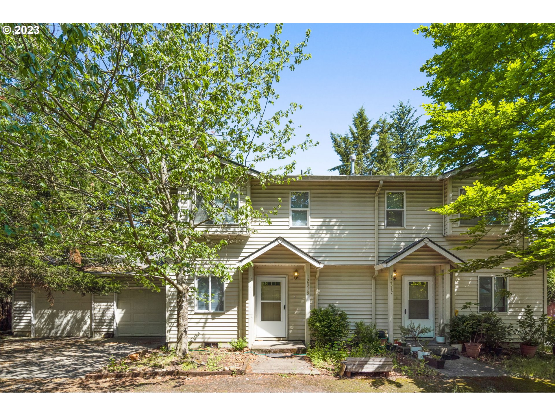 a front view of a house with a garden