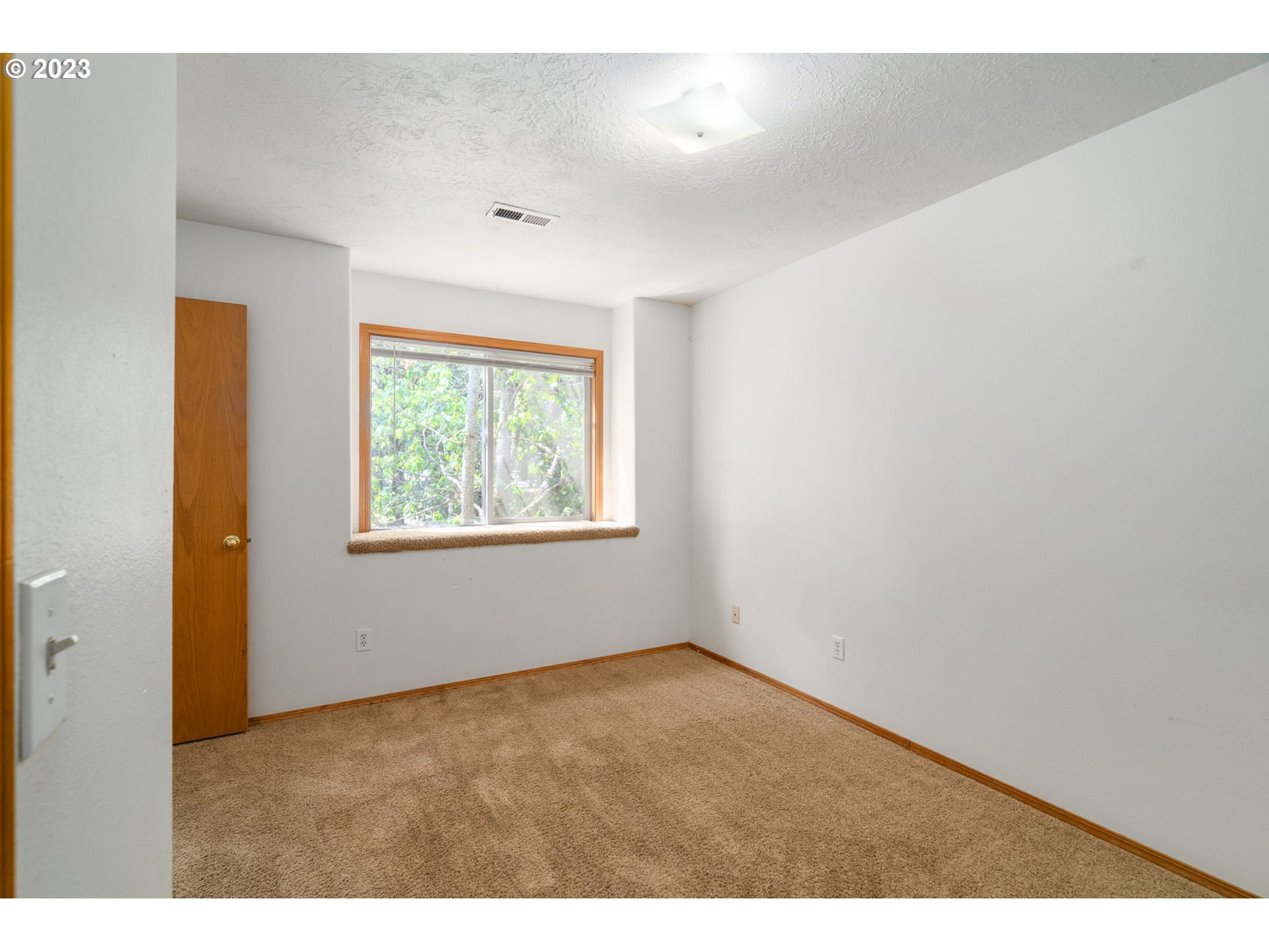 12315 Southeast Boise Street Portland, OR 97236 - Photo 14 of 23 a view of an empty room with a window