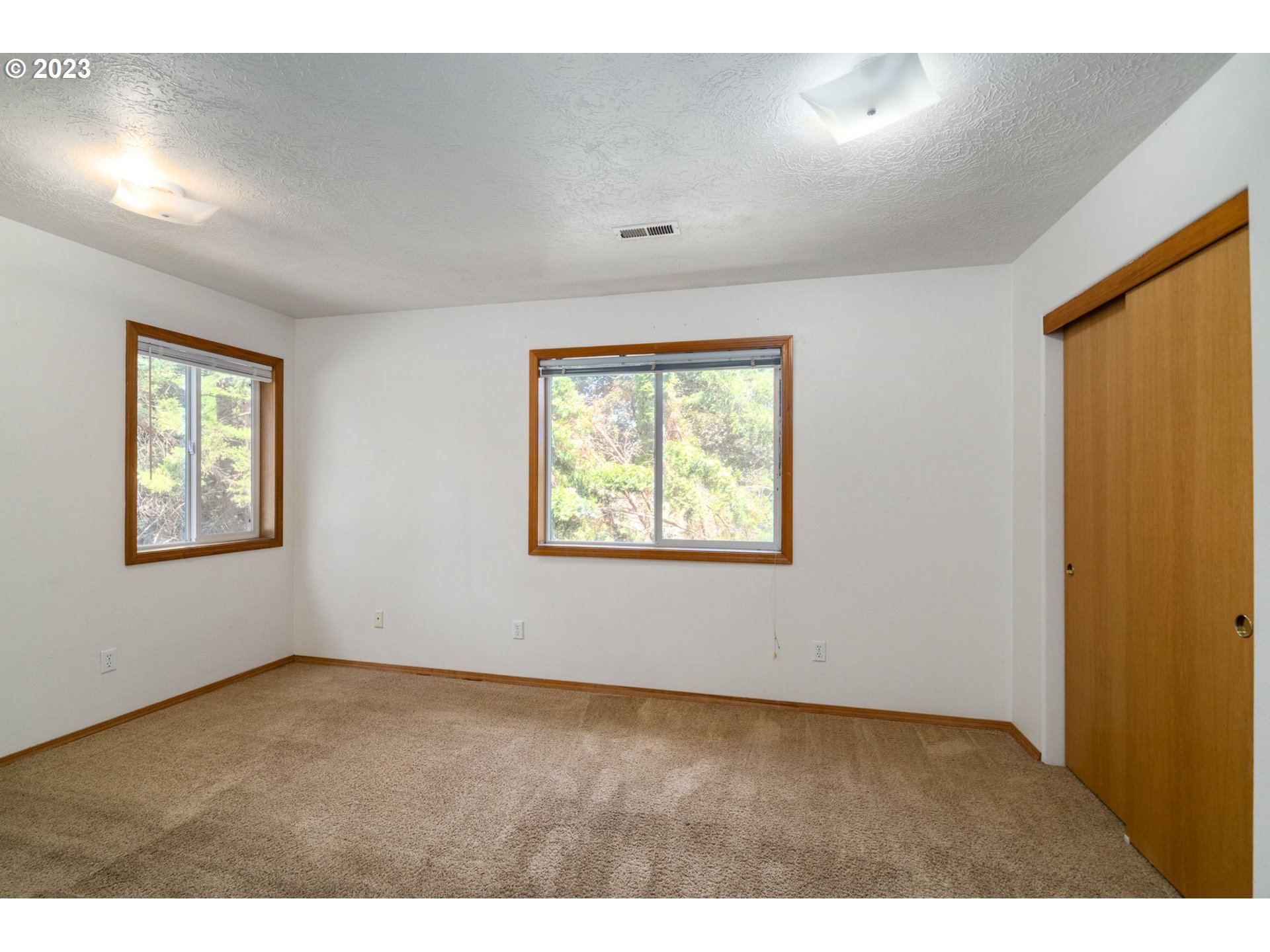 12315 Southeast Boise Street Portland, OR 97236 - Photo 17 of 23 a view of an empty room with a window