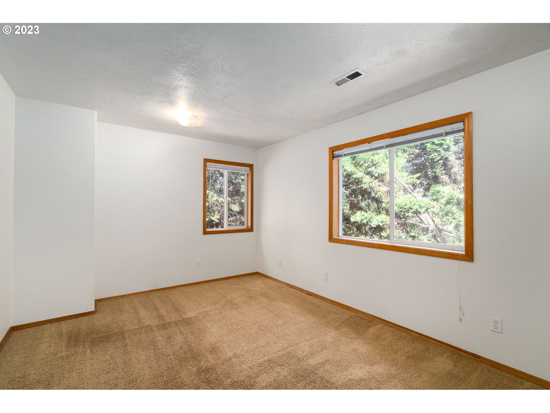 12315 Southeast Boise Street Portland, OR 97236 - Photo 18 of 23 a view of an empty room with a window