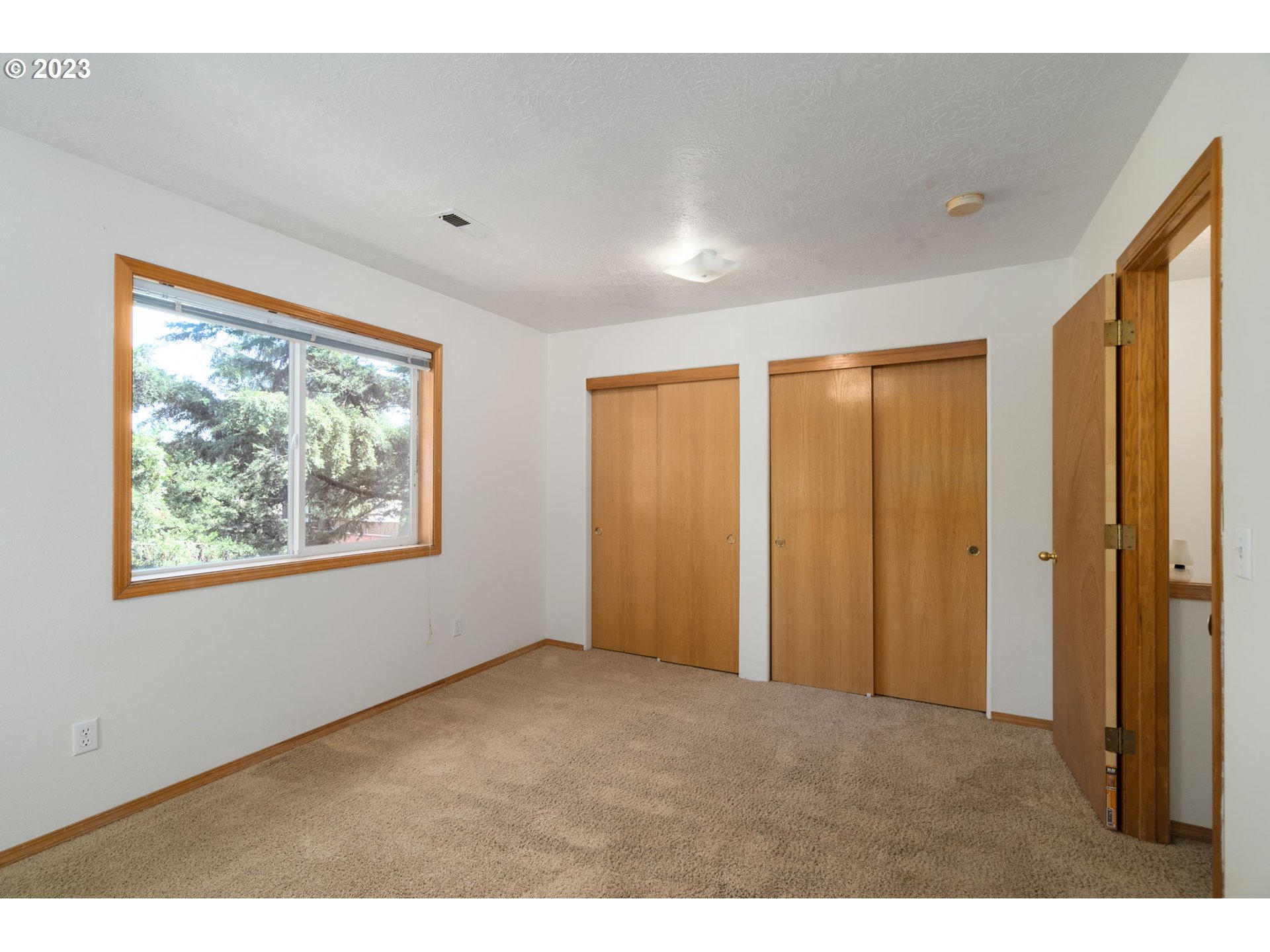 12315 Southeast Boise Street Portland, OR 97236 - Photo 19 of 23 a view of an empty room with windows