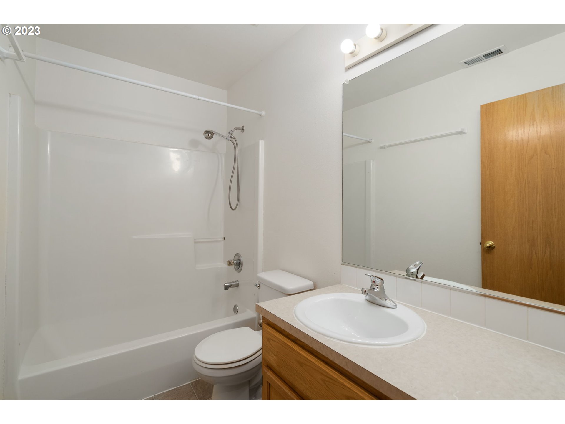12315 Southeast Boise Street Portland, OR 97236 - Photo 20 of 23 a bathroom with a sink toilet mirror and shower