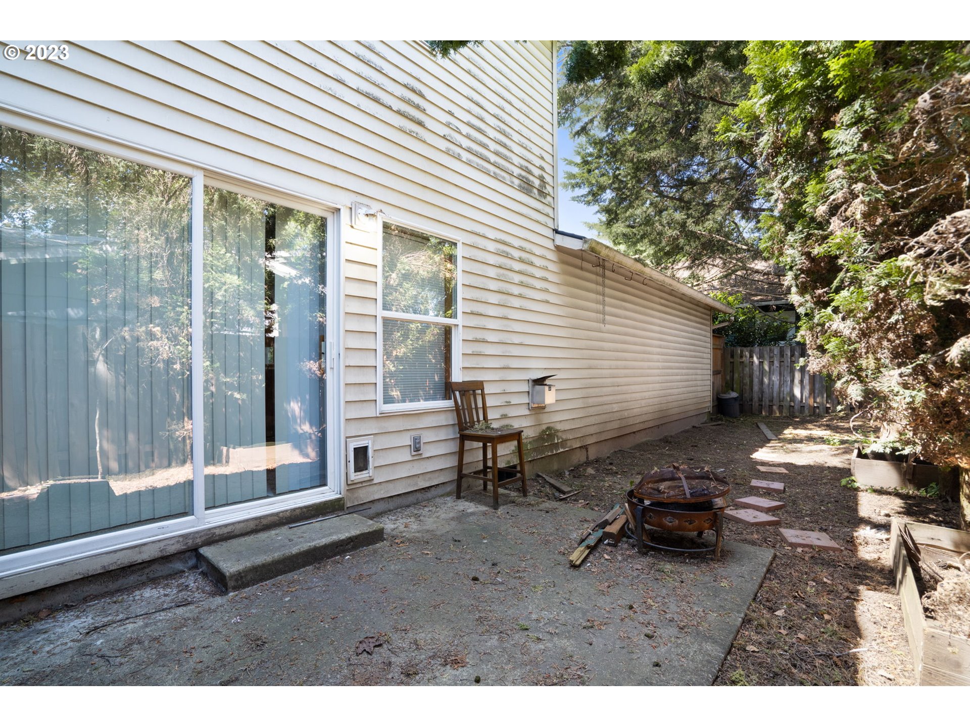 12315 Southeast Boise Street Portland, OR 97236 - Photo 22 of 23 a backyard of a house with barbeque oven table and chairs