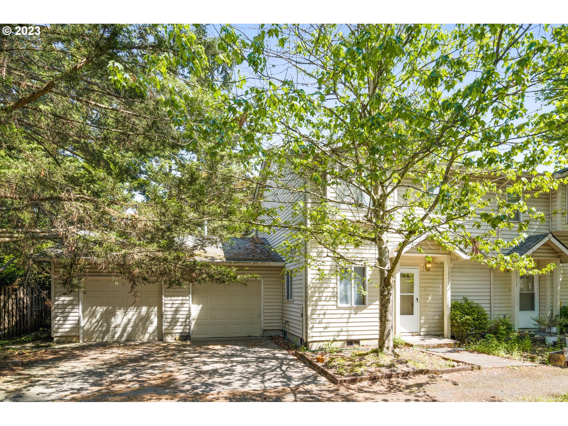 12315 Southeast Boise Street Portland, OR 97236 - Photo 3 of 23 a front view of a house with a garden