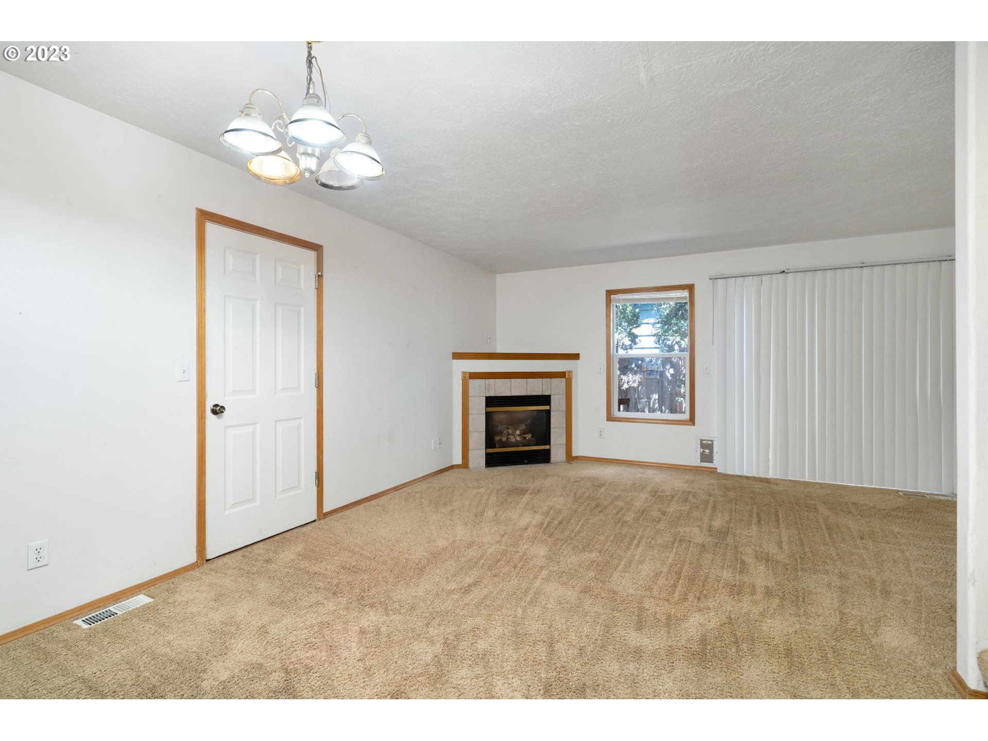 12315 Southeast Boise Street Portland, OR 97236 - Photo 5 of 23 a view of an empty room with a fireplace