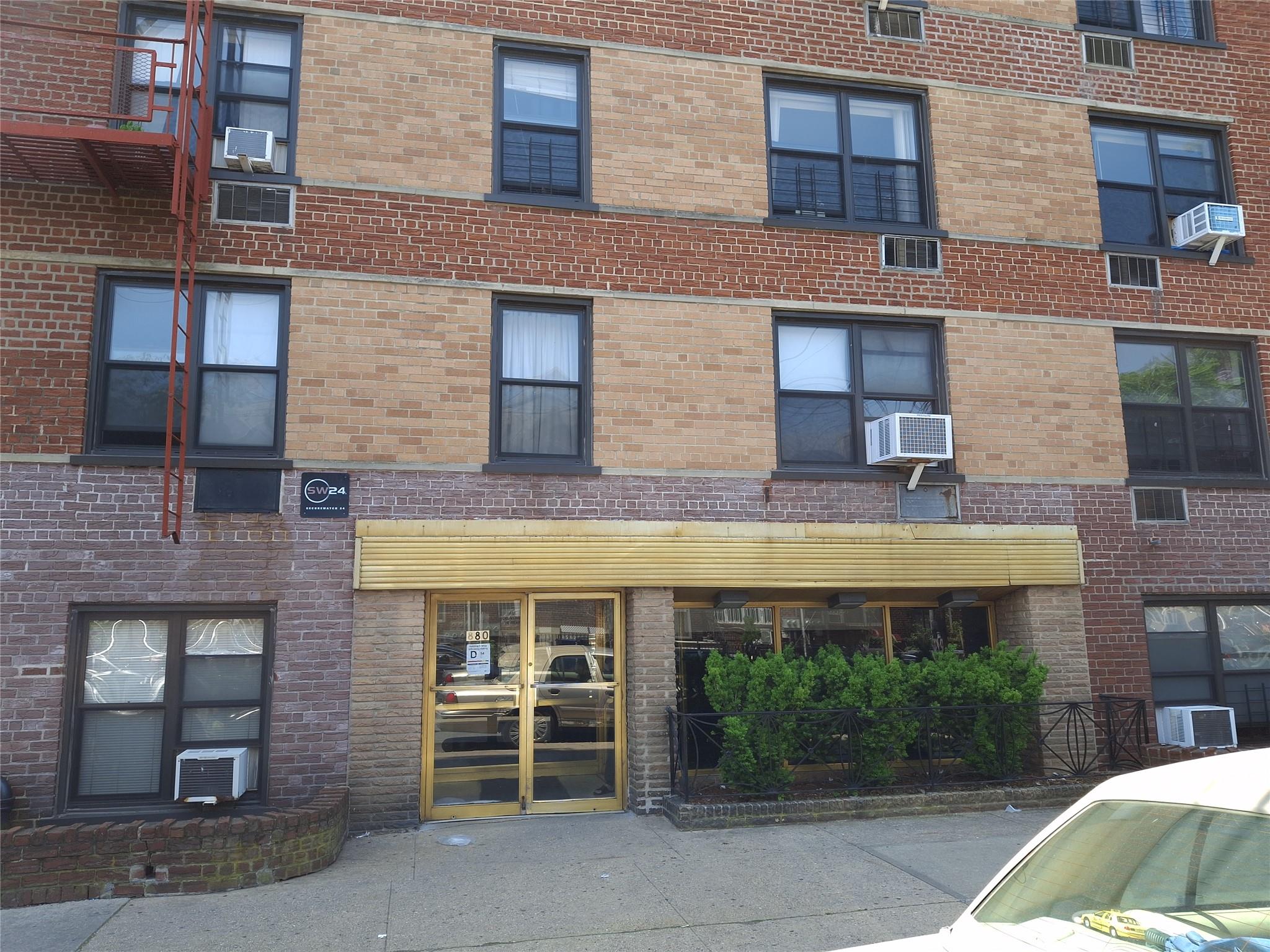 880 68th Street, Unit 1J Brooklyn, NY 11220 - Photo 1 of 1 a front view of a building with a garden and plants