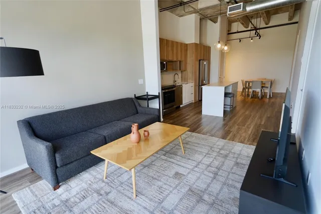 a living room with furniture and a wooden floor