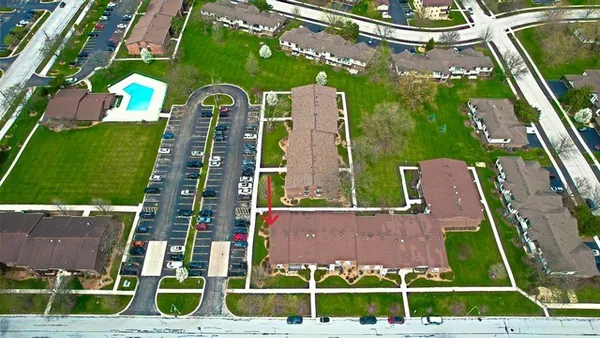 an aerial view of a residential apartment building with a yard