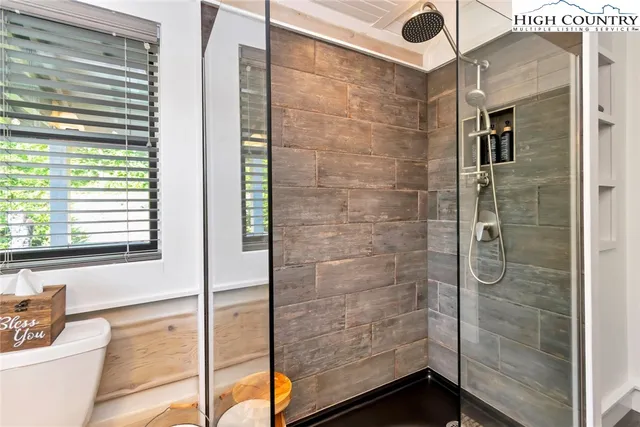 a bathroom with a shower and a sink