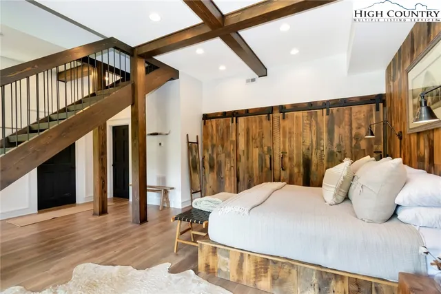 a bedroom with a bed and a large window