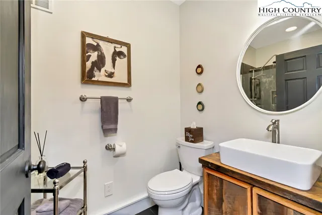 a bathroom with a sink mirror and toilet
