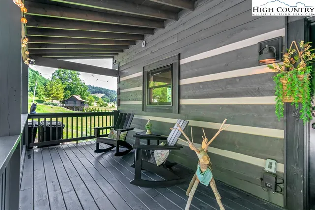a view of a deck with wooden floor and outdoor seating
