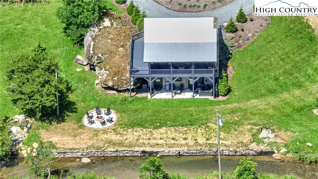a view of a backyard with table and chairs and potted plants