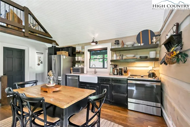 a kitchen with a table and chairs in it