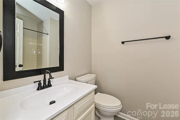 a bathroom with a sink toilet and mirror