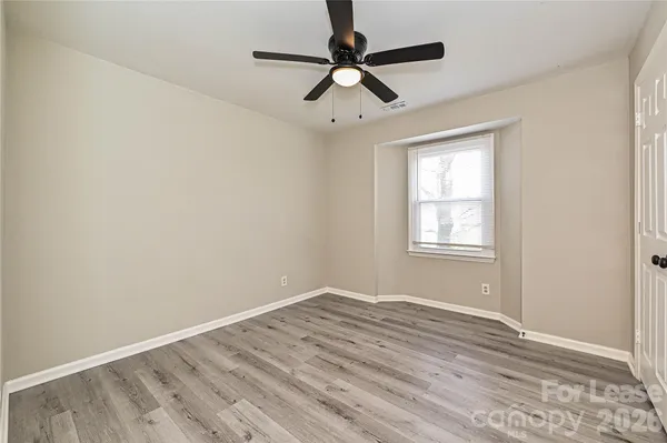 a view of room with window and ceiling fan