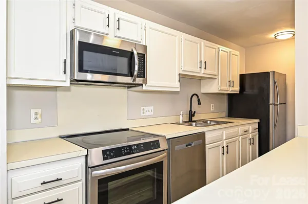 a kitchen with a stove and a microwave
