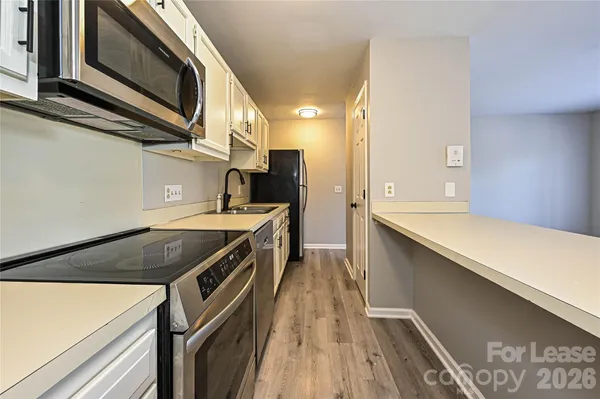 a kitchen with stainless steel appliances granite countertop a sink and a stove