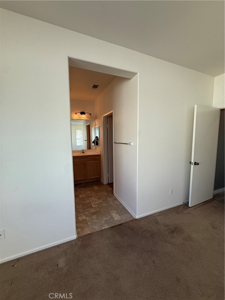 2062 Splendid Circle San Jacinto, CA 92582 - Photo 14 of 18 an empty room with an entrance and wooden floor