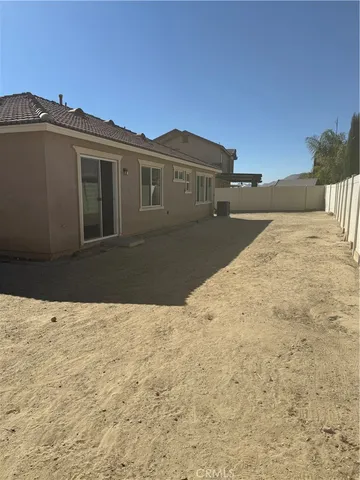 a view of house with yard and car parked