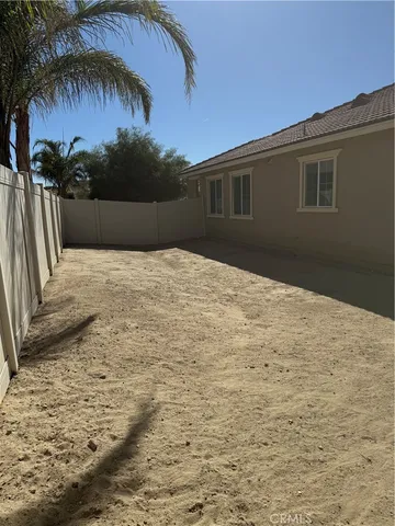 a backyard of a house with palm trees