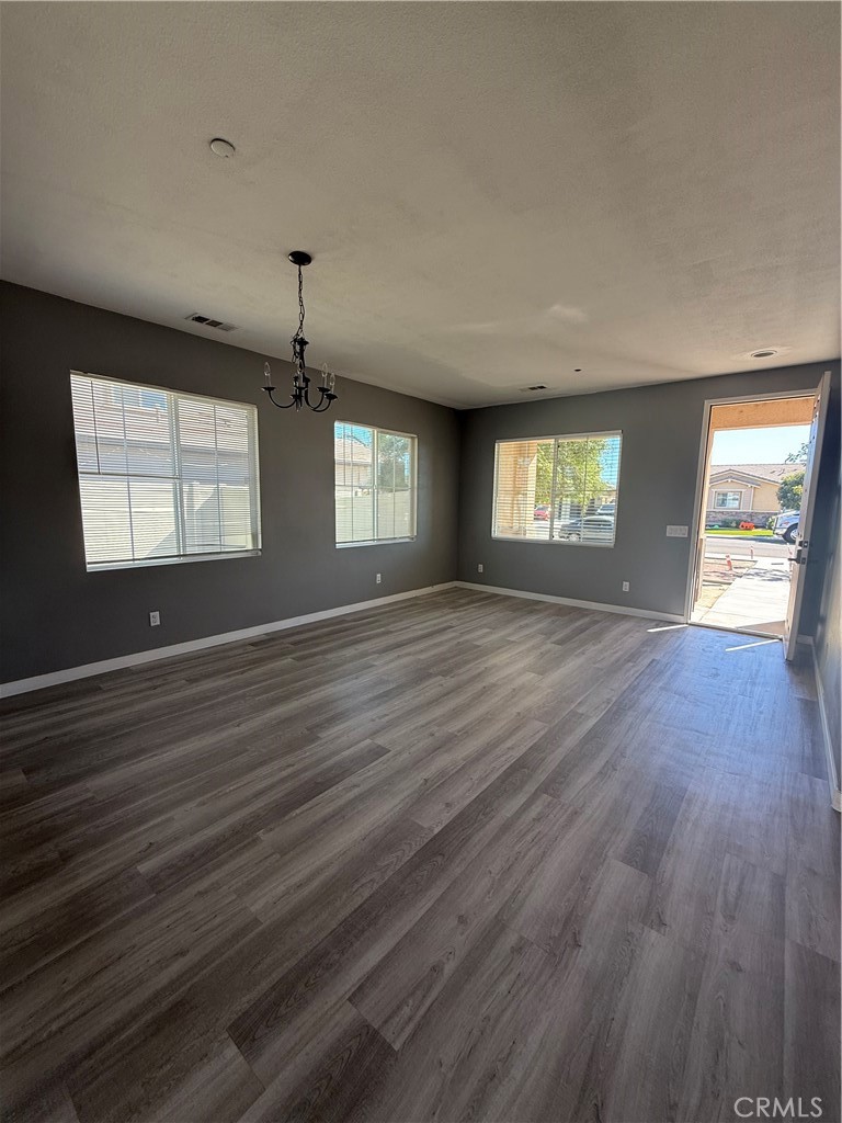 2062 Splendid Circle San Jacinto, CA 92582 - Photo 3 of 18 an empty room with wooden floor and windows