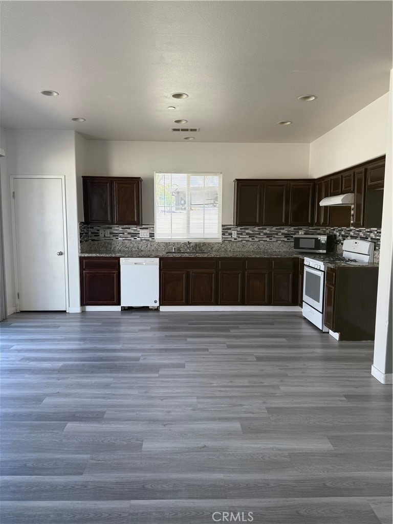 2062 Splendid Circle San Jacinto, CA 92582 - Photo 5 of 18 a large kitchen with stainless steel appliances wooden floor and a kitchen island