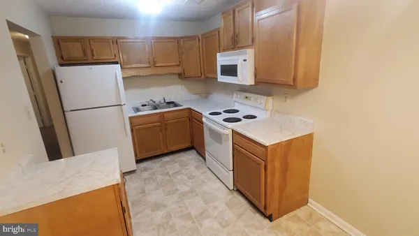 a kitchen with a refrigerator stove and microwave