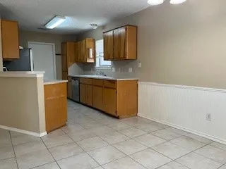 a kitchen with stainless steel appliances granite countertop a refrigerator sink and microwave