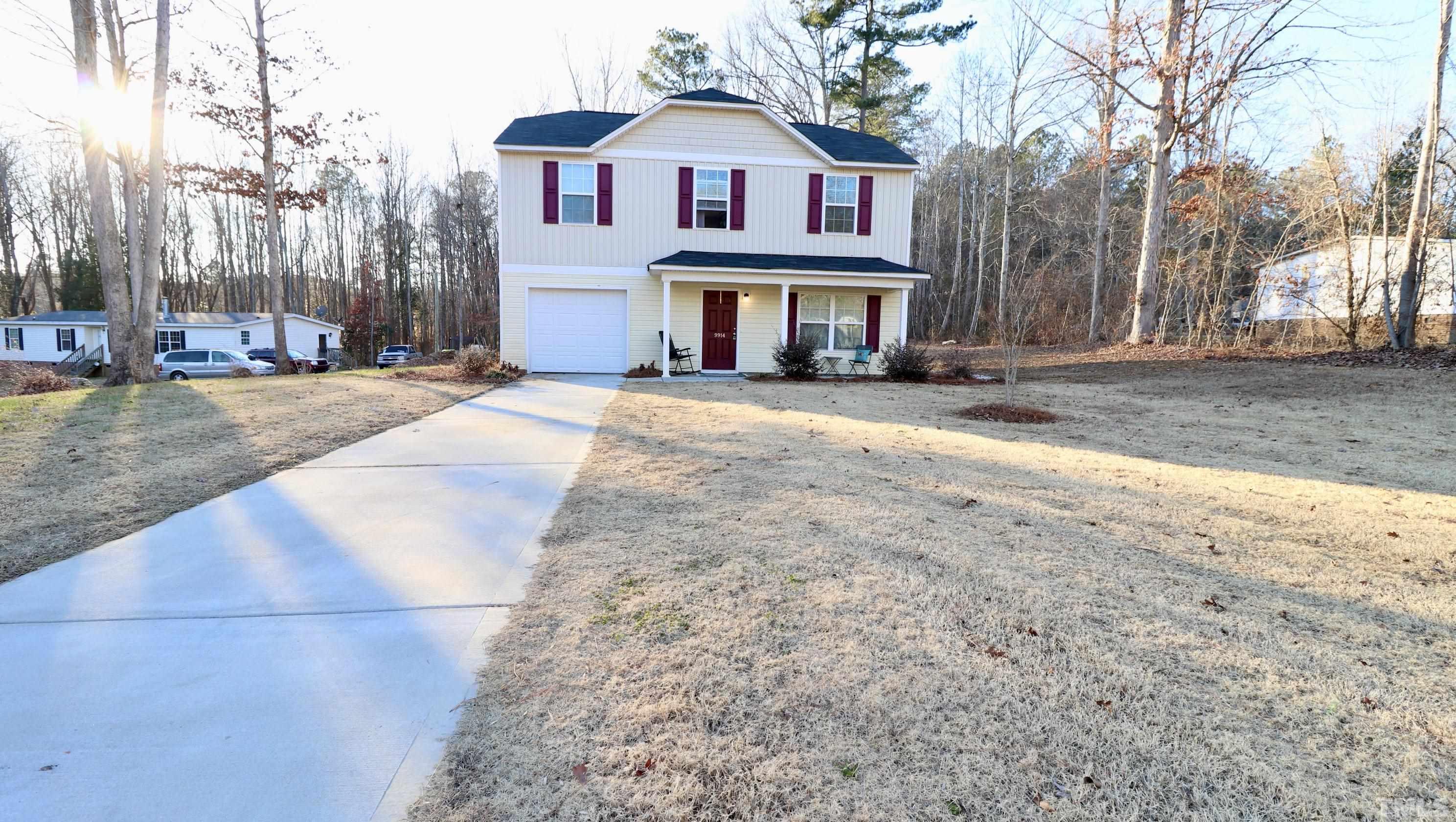 9914 Nugget Road Spring Hope, NC 27882 - Photo 1 of 10 a front view of a house with a yard and garage