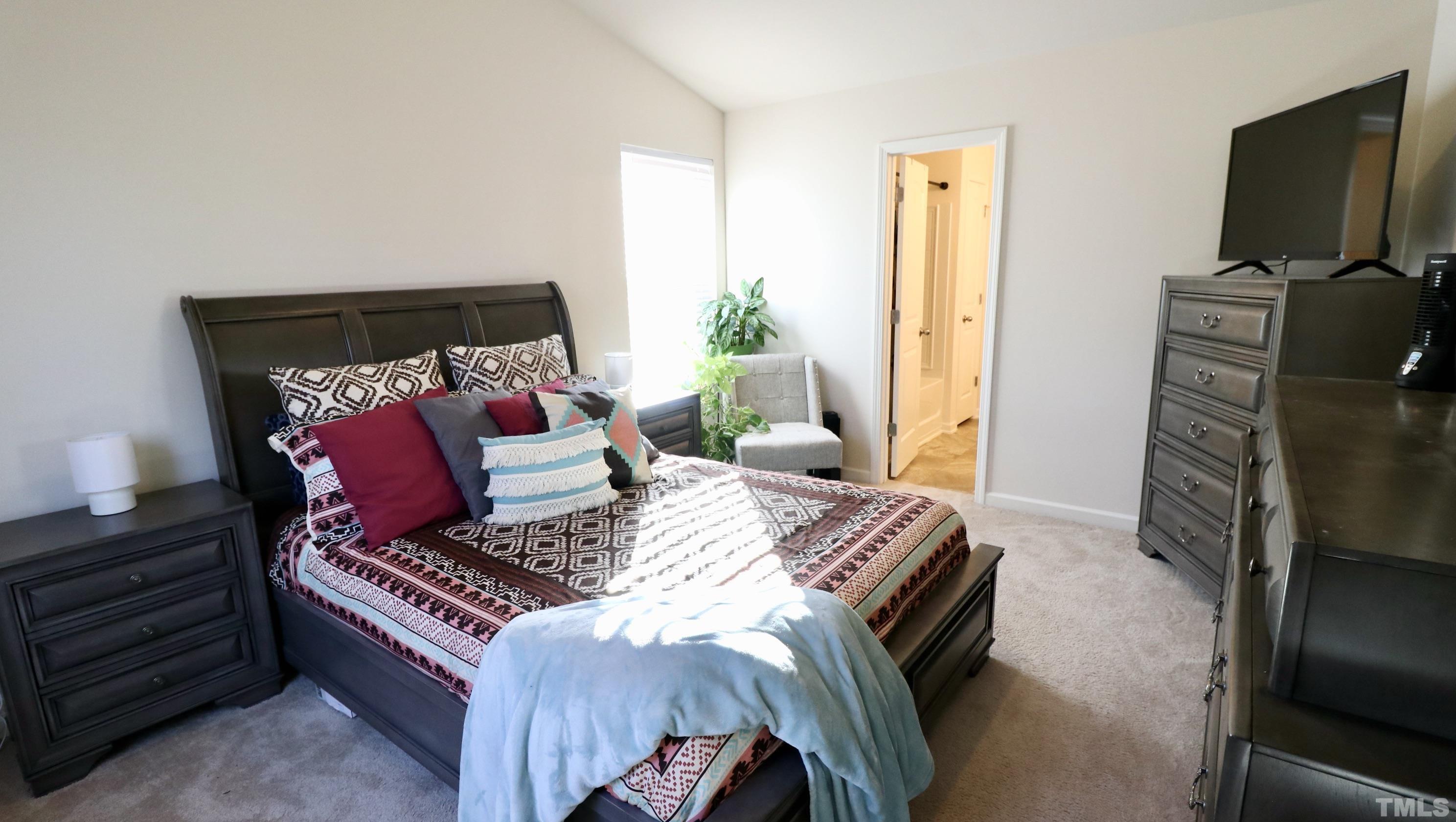 9914 Nugget Road Spring Hope, NC 27882 - Photo 4 of 10 a bedroom with a bed and flat screen tv
