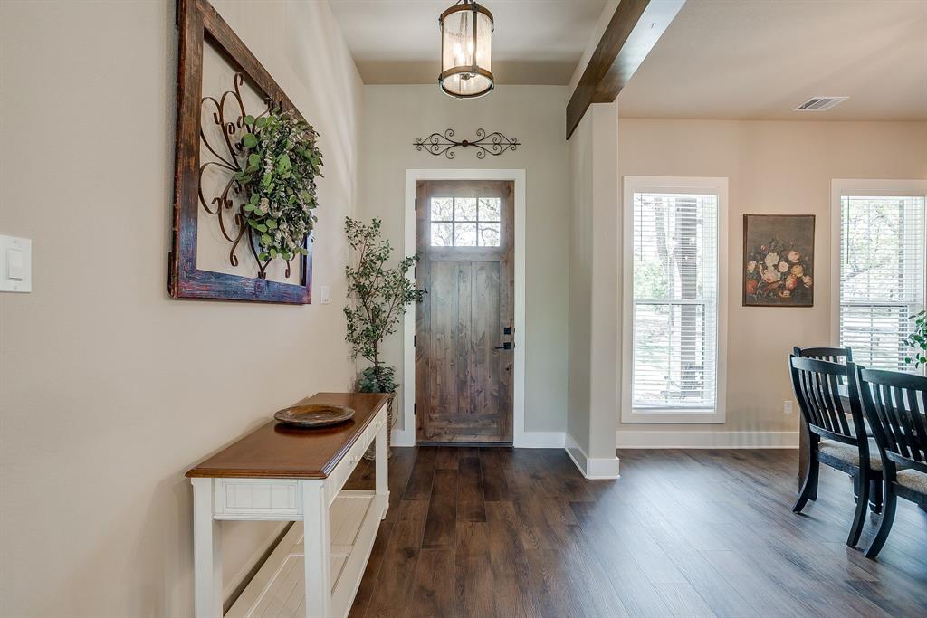322 Mountainview Court Sunset, TX 76270 - Photo 12 of 40 a view of hallway with wooden floor and fan
