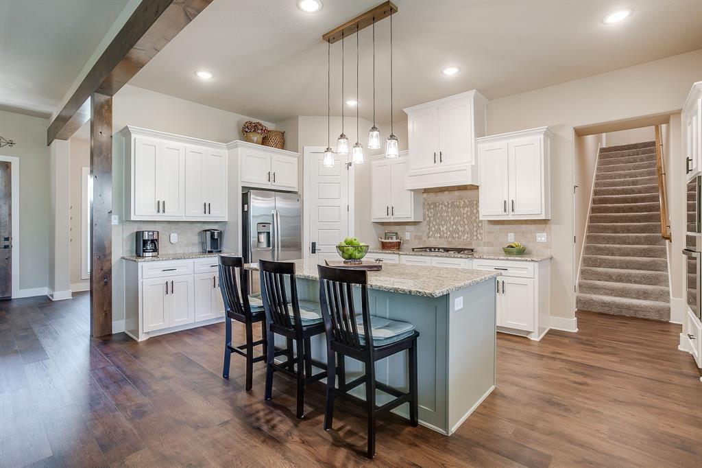 322 Mountainview Court Sunset, TX 76270 - Photo 15 of 40 a kitchen with stainless steel appliances a white cabinets wooden floors and a sink