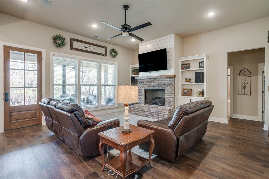 322 Mountainview Court Sunset, TX 76270 - Photo 19 of 40 a living room with fireplace furniture and a flat screen tv