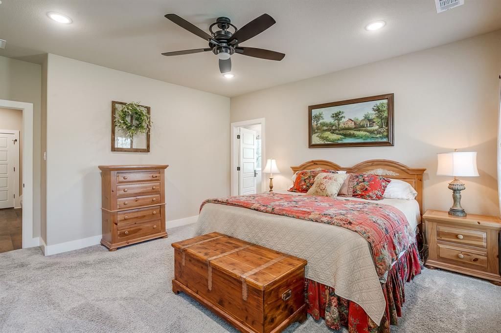 322 Mountainview Court Sunset, TX 76270 - Photo 23 of 40 a spacious bedroom with a bed and a ceiling fan