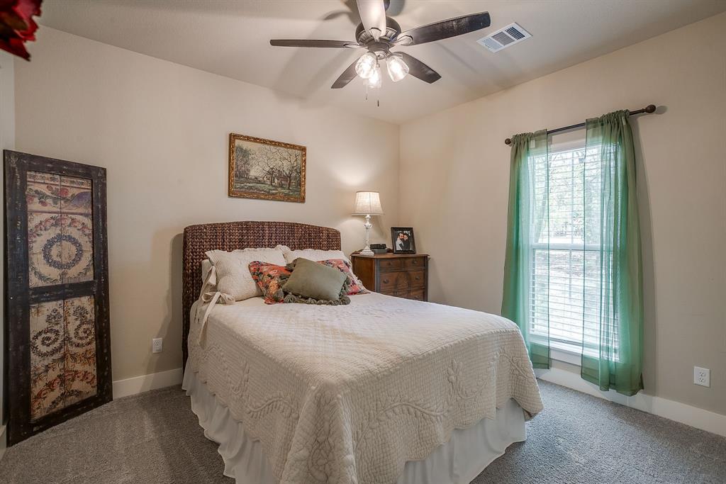 322 Mountainview Court Sunset, TX 76270 - Photo 30 of 40 a bedroom with a bed and a window