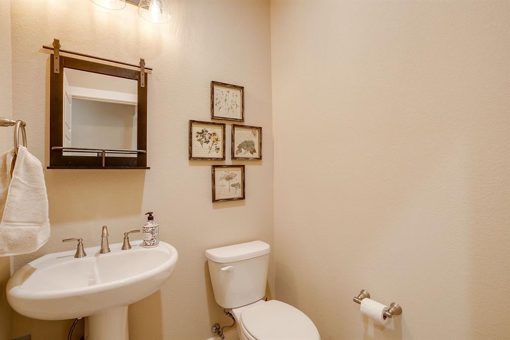 322 Mountainview Court Sunset, TX 76270 - Photo 32 of 40 a bathroom with a toilet sink and mirror