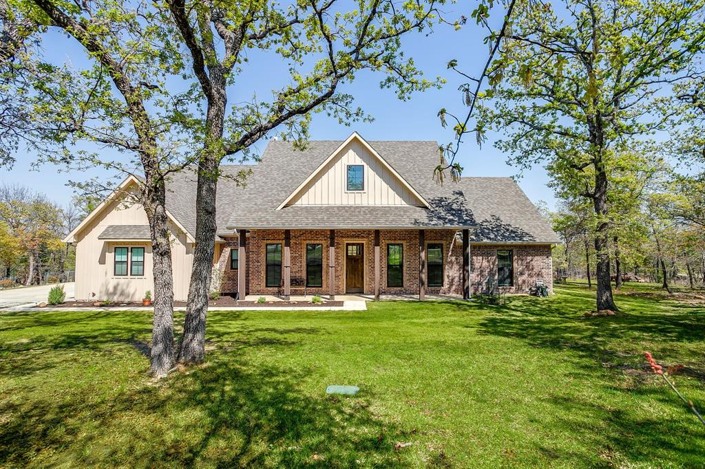 322 Mountainview Court Sunset, TX 76270 - Photo 9 of 40 a front view of a house with a garden