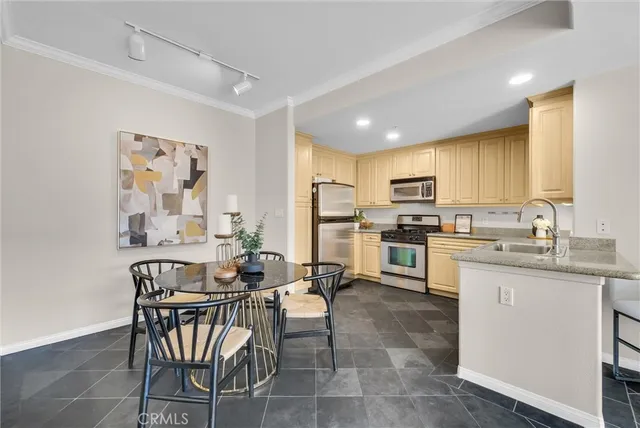a kitchen with cabinets stainless steel appliances and wooden floor