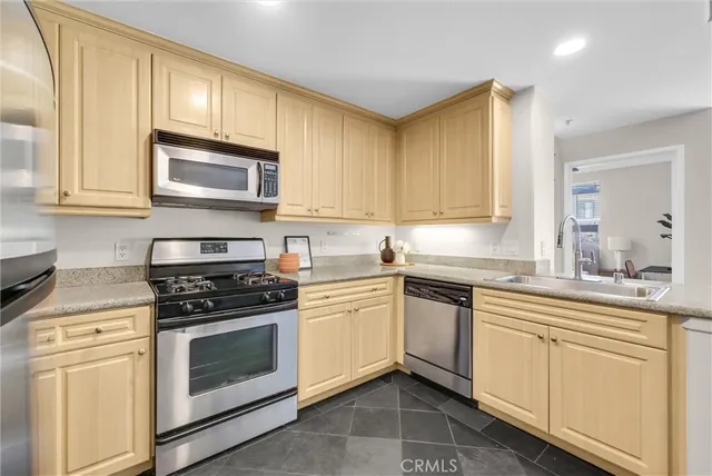 a kitchen with a refrigerator and table chair