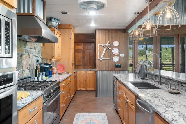 a front view of a house with garden and plants