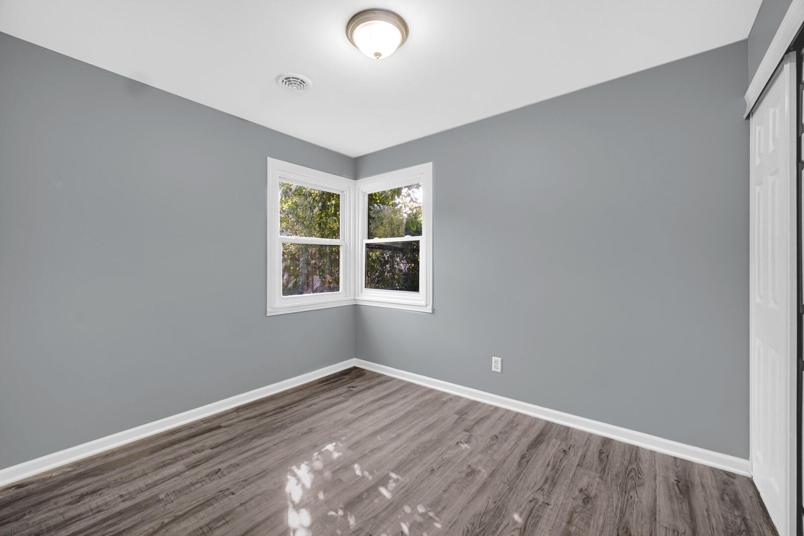 1159 Fayette Street Gary, IN 46403 - Photo 11 of 19 an empty room with wooden floor and windows