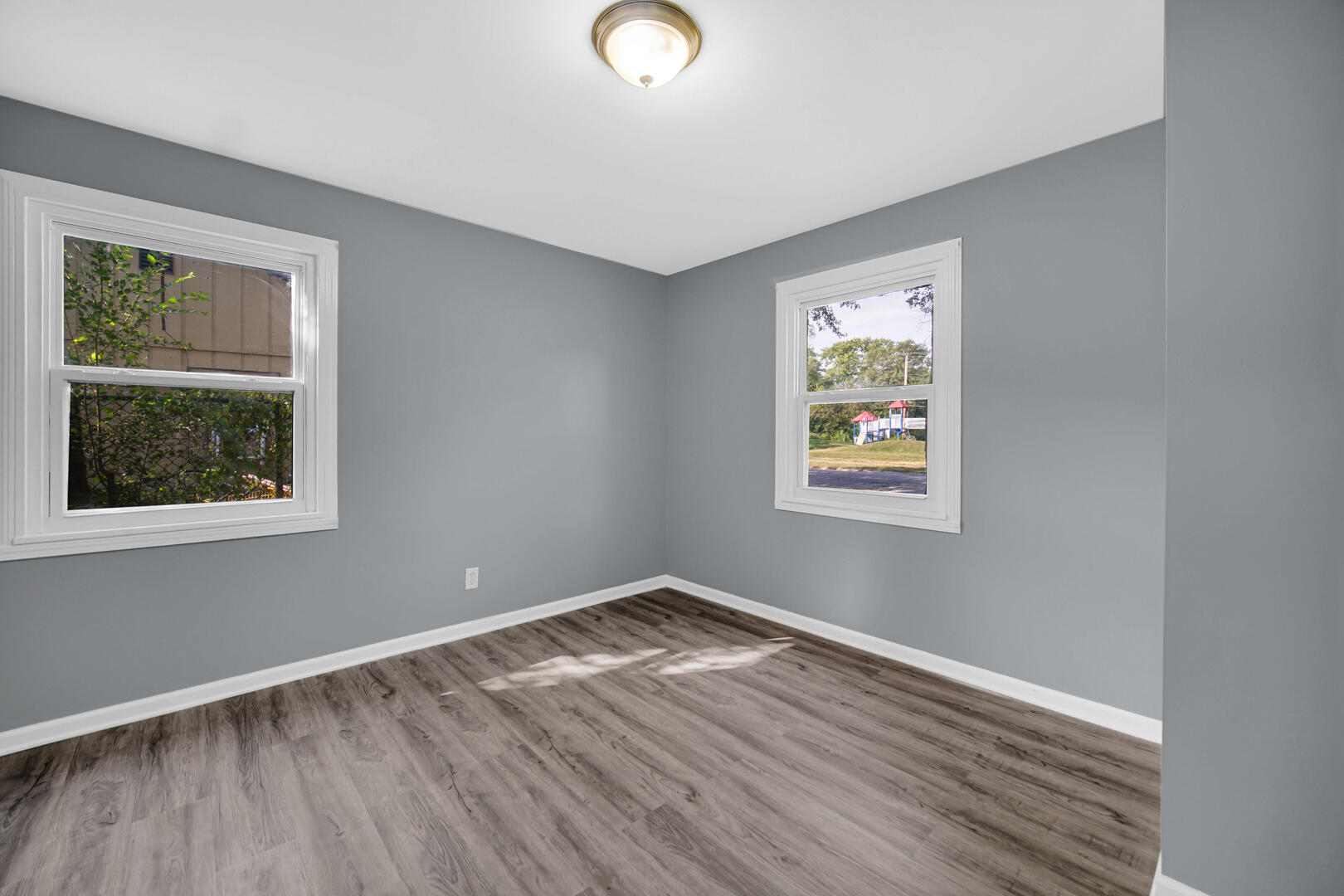 1159 Fayette Street Gary, IN 46403 - Photo 13 of 19 a view of an empty room with wooden floor and a window