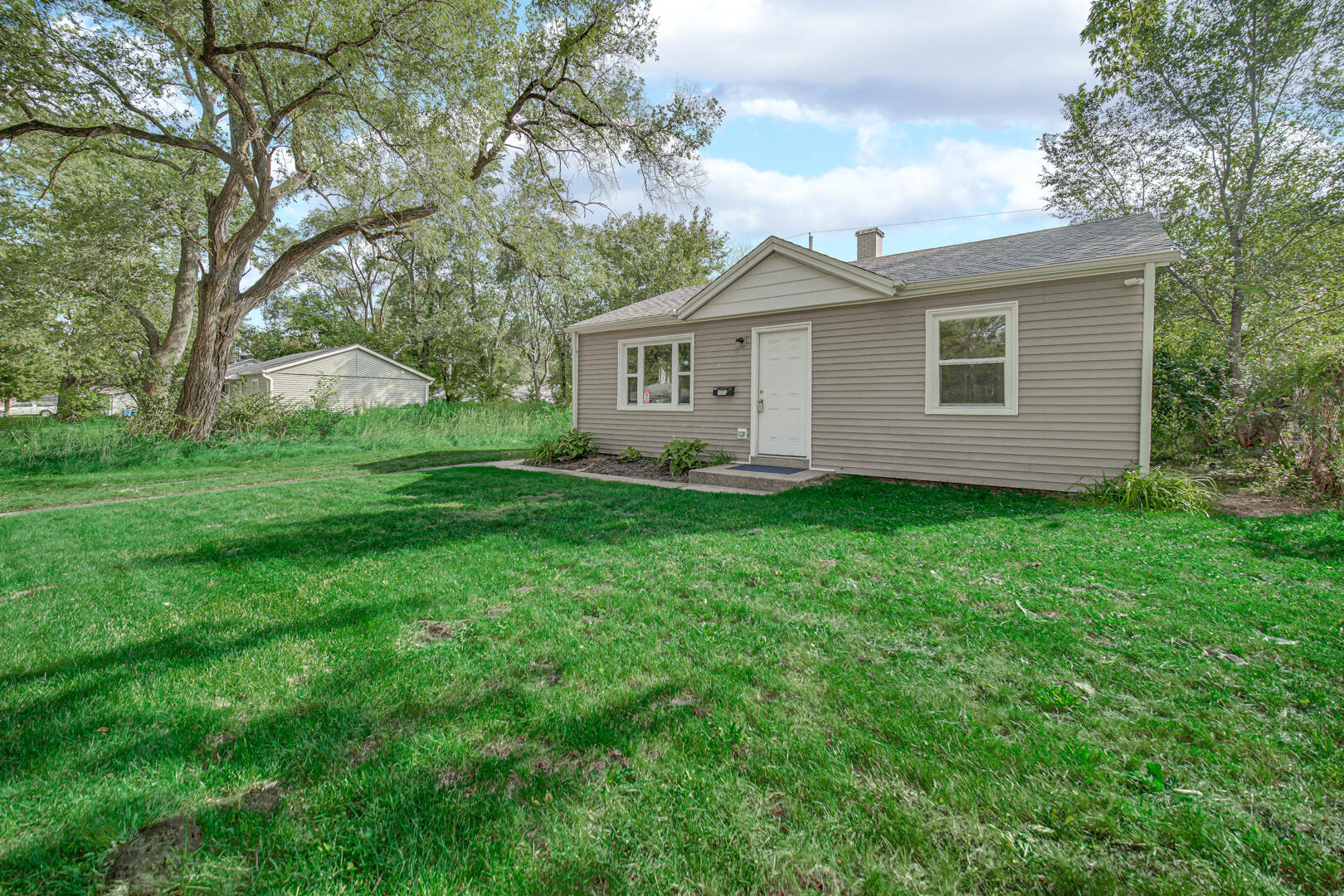 1159 Fayette Street Gary, IN 46403 - Photo 17 of 19 a view of a house with yard and large trees