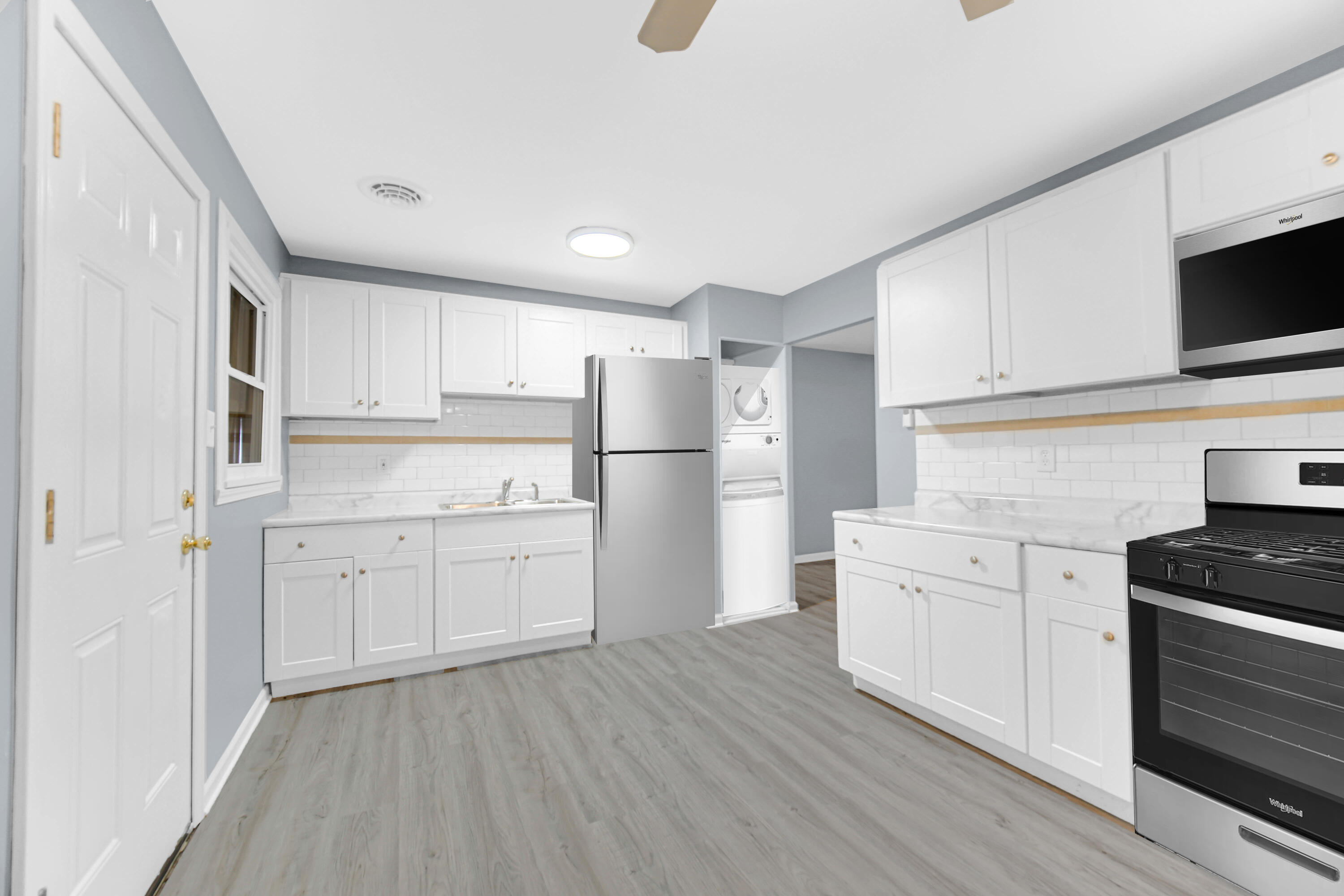 1159 Fayette Street Gary, IN 46403 - Photo 2 of 19 a kitchen with white cabinets stainless steel appliances and wooden floor